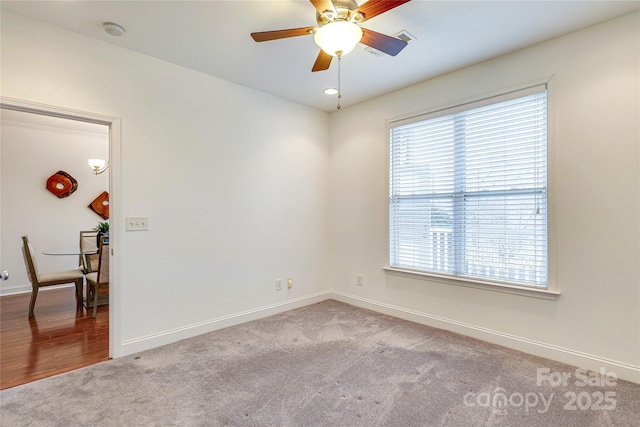 unfurnished room featuring a ceiling fan, baseboards, and carpet floors