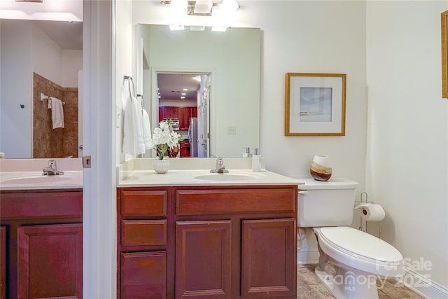 full bath with vanity, toilet, and tiled shower