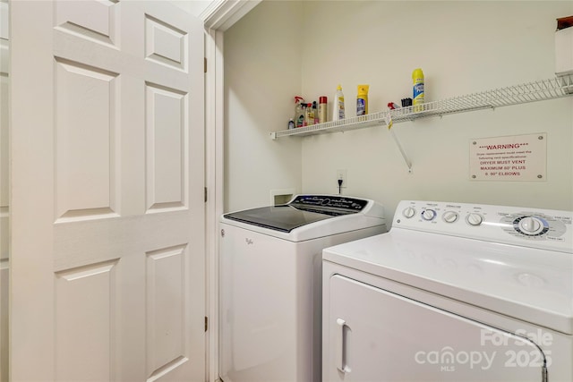 clothes washing area featuring washing machine and dryer and laundry area