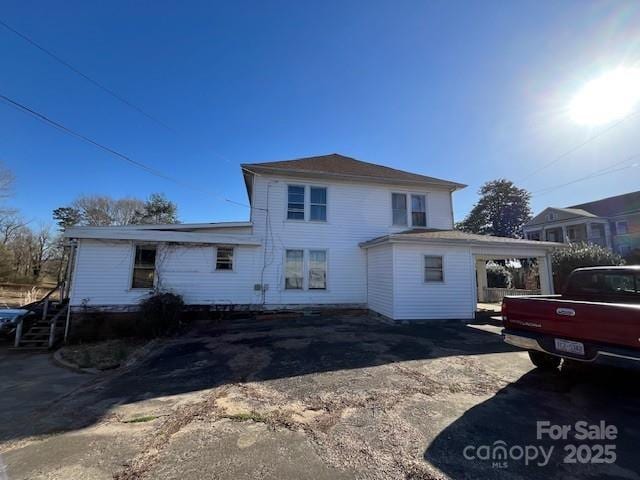 rear view of house with driveway