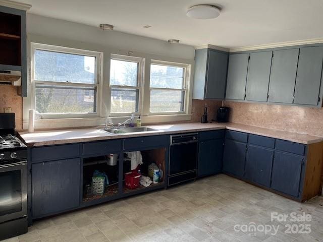 kitchen featuring a sink, black appliances, light countertops, under cabinet range hood, and backsplash