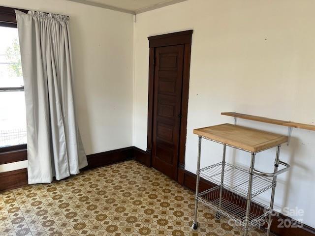 interior space with tile patterned floors and baseboards