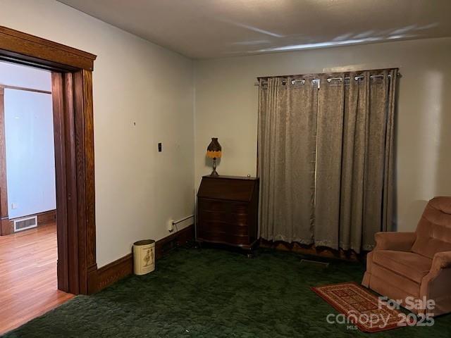 unfurnished bedroom featuring carpet and visible vents