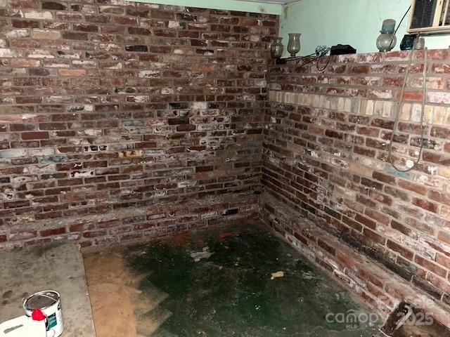 bathroom featuring brick wall