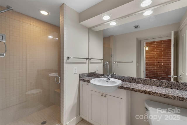 bathroom with vanity, visible vents, recessed lighting, a shower stall, and toilet