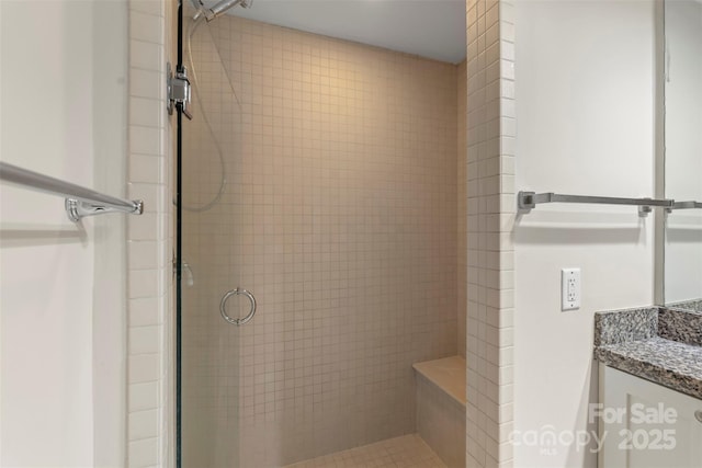 bathroom featuring a shower stall and vanity