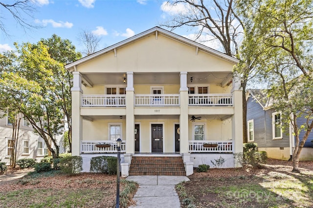 neoclassical / greek revival house with stucco siding, a porch, and a balcony