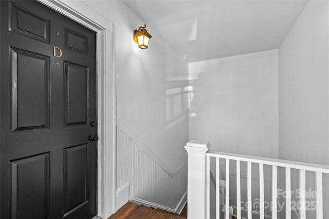 interior space featuring a decorative wall and wood finished floors