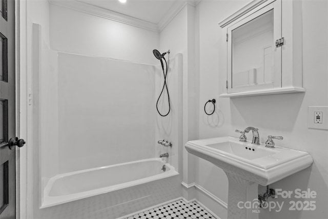 bathroom featuring a sink, washtub / shower combination, and ornamental molding