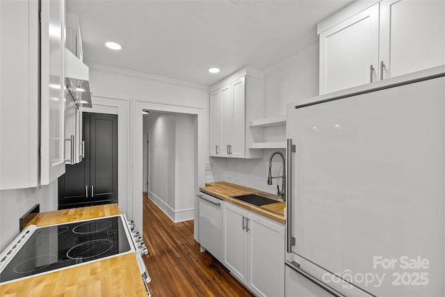 kitchen featuring butcher block countertops, a sink, open shelves, white appliances, and white cabinets