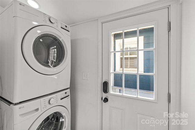 clothes washing area with laundry area and stacked washing maching and dryer