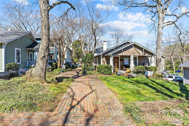 exterior space with a chimney and a yard