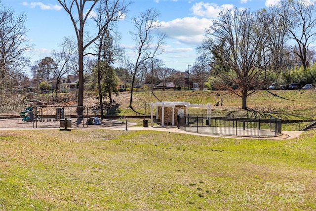 view of yard with playground community and fence