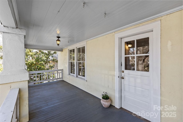 wooden terrace featuring covered porch