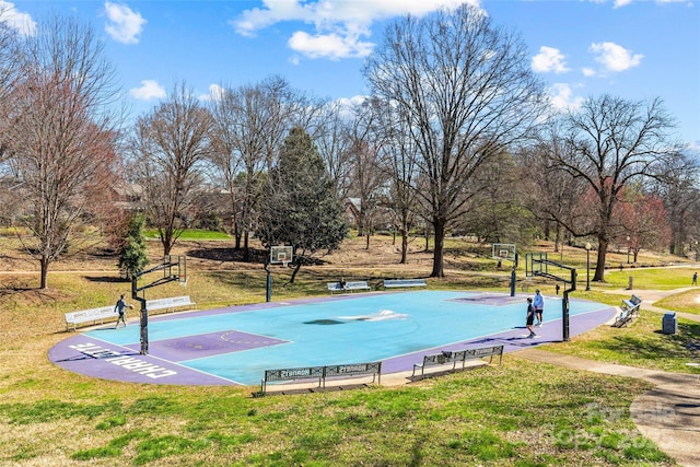 view of property's community with community basketball court and a lawn