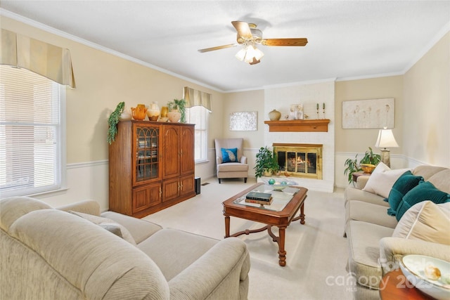 carpeted living room featuring plenty of natural light, a fireplace, and ornamental molding