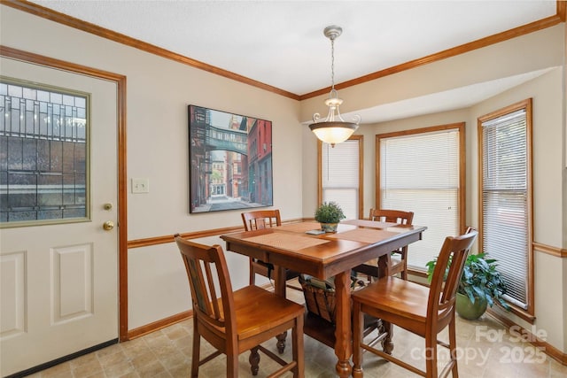 dining room featuring baseboards and ornamental molding