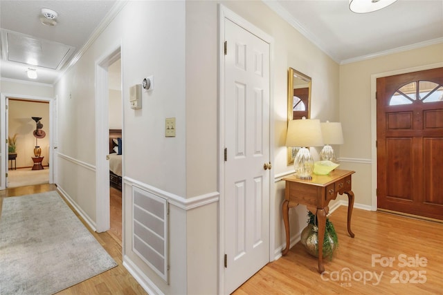 entrance foyer with crown molding and light wood-type flooring