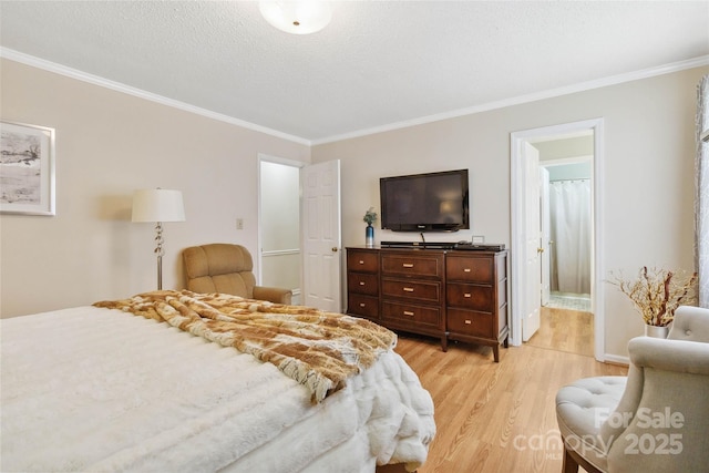 bedroom featuring a textured ceiling, ornamental molding, and light wood finished floors