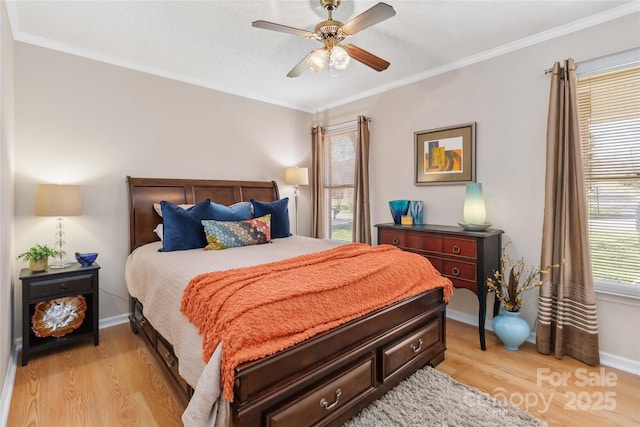 bedroom with light wood finished floors, baseboards, and ornamental molding