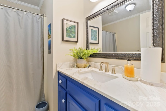 full bath featuring vanity, visible vents, and ornamental molding