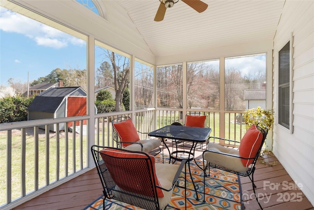 sunroom featuring lofted ceiling and ceiling fan