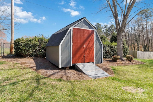 view of shed featuring fence