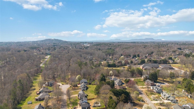 birds eye view of property with a residential view, a mountain view, and a wooded view