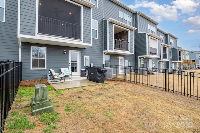 rear view of property featuring a patio, a fenced backyard, and a residential view