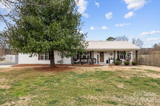 single story home featuring a porch, a front lawn, and metal roof