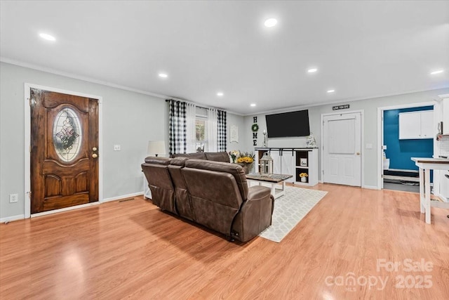 living room featuring recessed lighting, baseboards, crown molding, and light wood-style floors