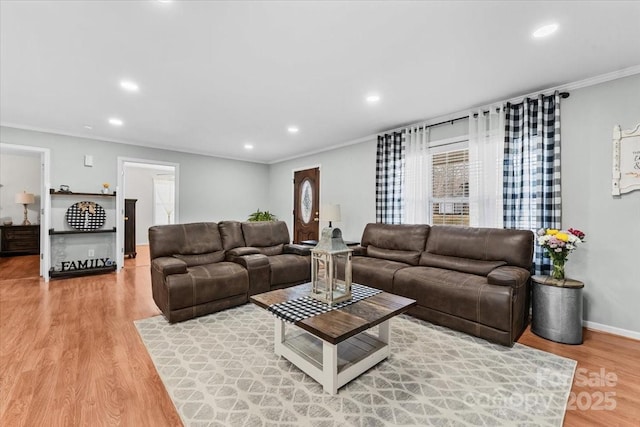living room featuring crown molding, recessed lighting, light wood-type flooring, and a wealth of natural light