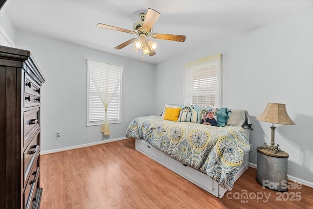 bedroom featuring wood finished floors, baseboards, and ceiling fan