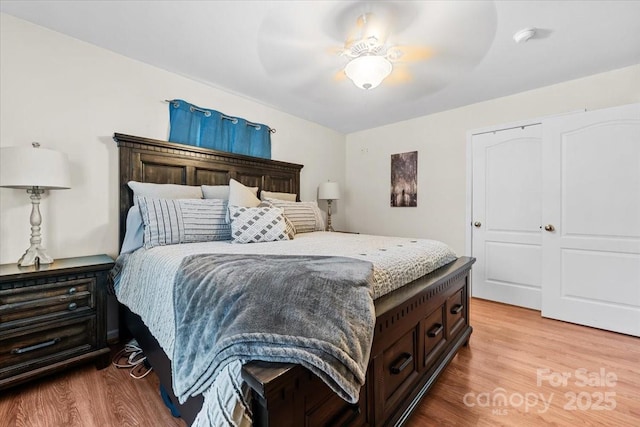 bedroom featuring light wood-style flooring and ceiling fan