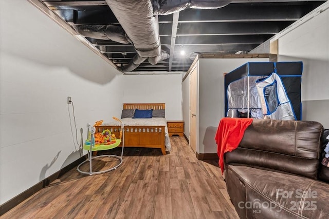 bedroom featuring baseboards and wood finished floors