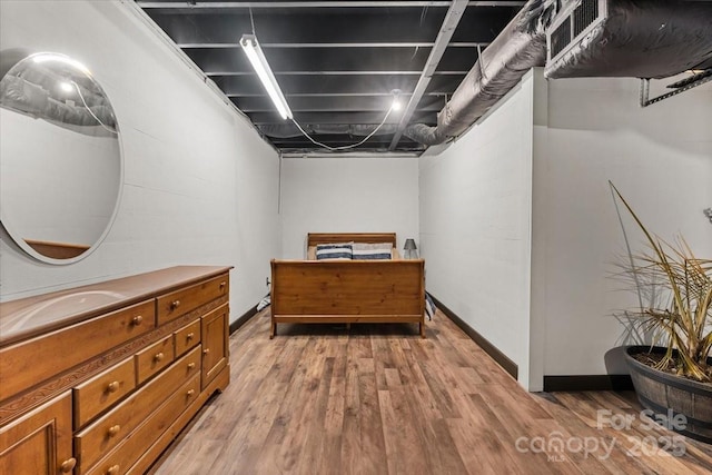 interior space with baseboards and wood finished floors