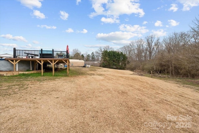 view of yard with a wooden deck