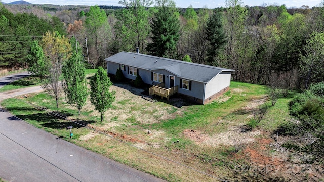 birds eye view of property with a forest view