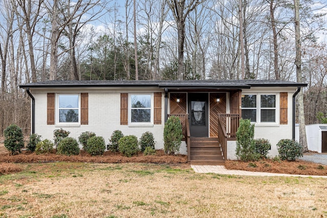 view of front facade featuring a front yard and brick siding