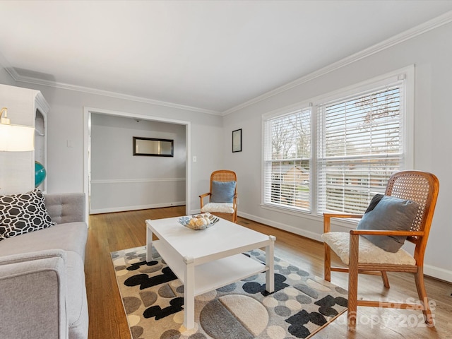 living room with crown molding, baseboards, and wood finished floors