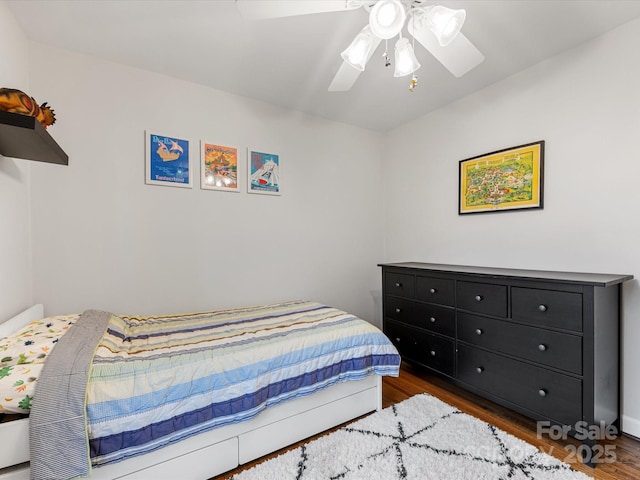 bedroom featuring a ceiling fan and wood finished floors