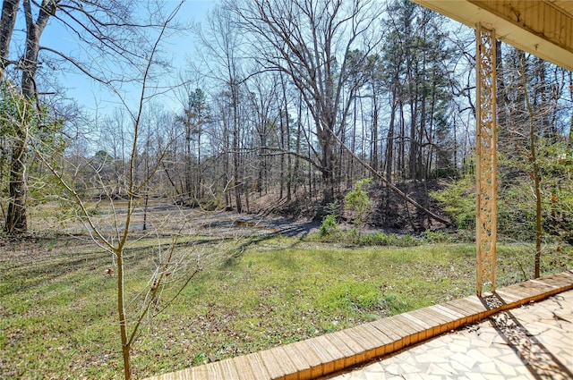 view of yard with a view of trees