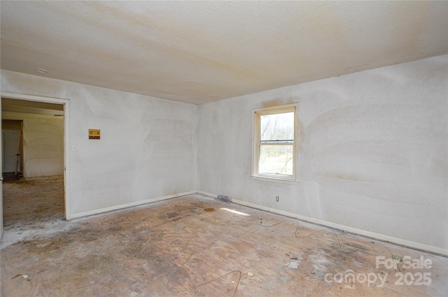 spare room with a textured ceiling