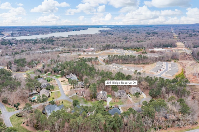 aerial view with a view of trees and a water view