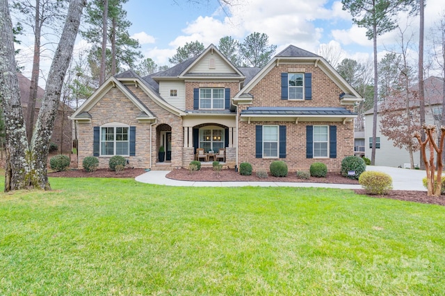 craftsman-style house with brick siding, roof with shingles, and a front lawn