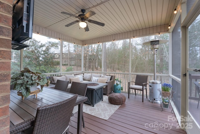 sunroom / solarium with wood ceiling and ceiling fan