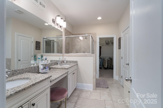 bathroom with vanity, visible vents, a stall shower, tile patterned flooring, and a walk in closet