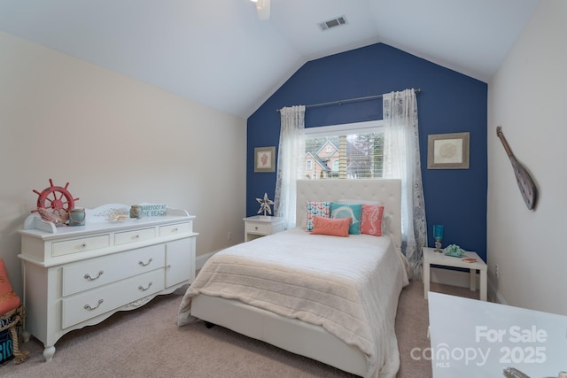 carpeted bedroom featuring lofted ceiling, visible vents, and ceiling fan