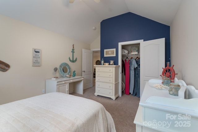 bedroom with a closet, light colored carpet, a ceiling fan, and vaulted ceiling