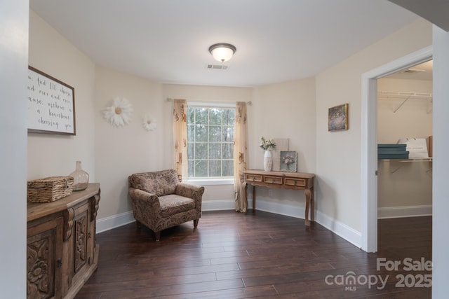 sitting room featuring wood finished floors, visible vents, and baseboards